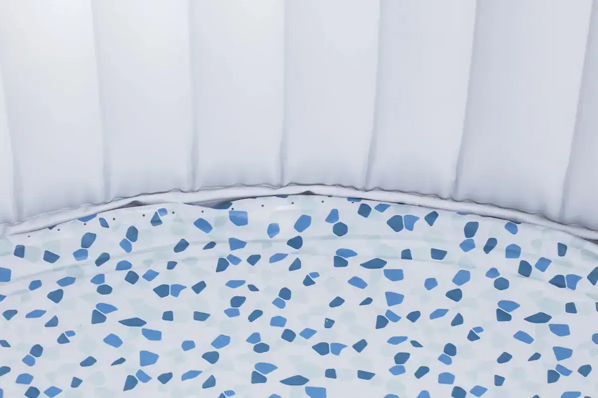 Pool mit blauem Mosaikboden und weißer Einfassung.